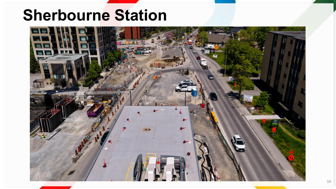 Photo of Sherbourne station showing the roof of the headhouse, including construction vehicles and lots (lots!) of pylons