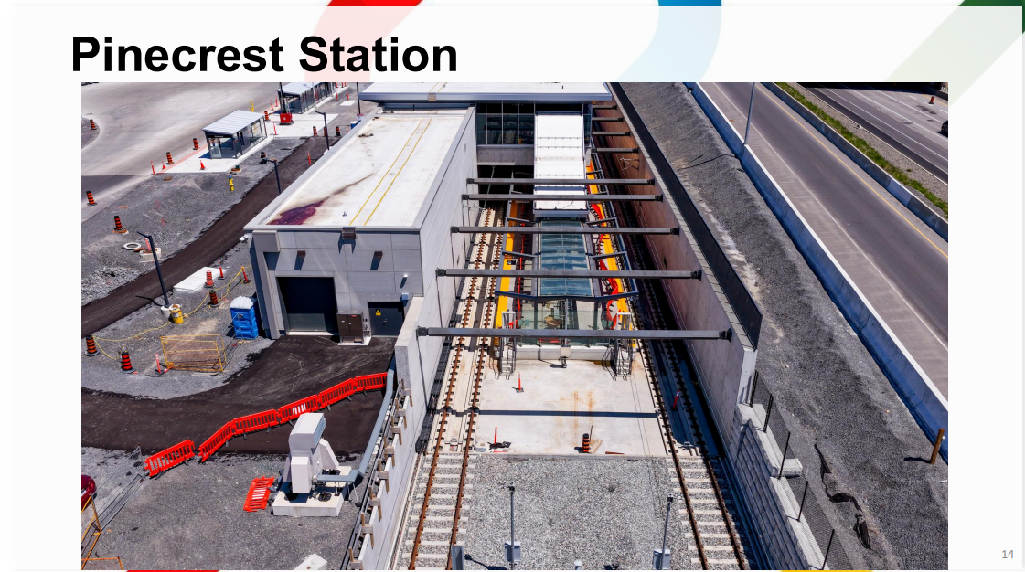 Aerial photo of Pinecrest with bus shelters visible, fencing at track level, and many finishings installed